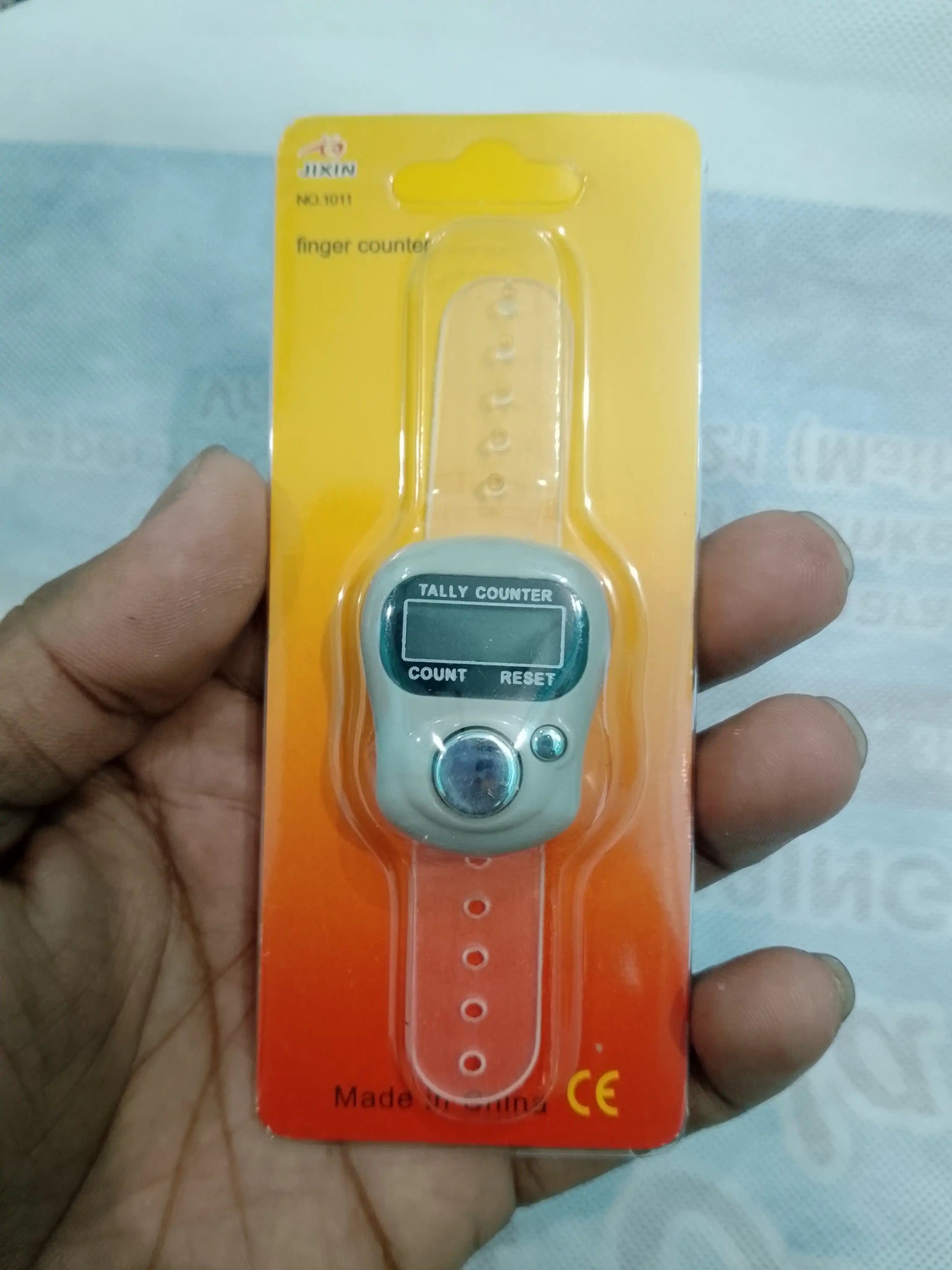 Digital finger counter on a hand with a blurred background