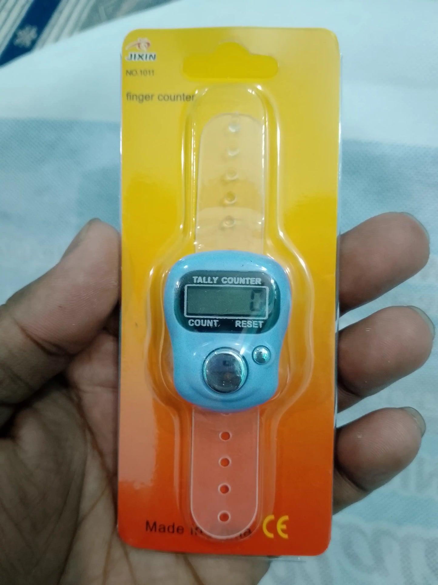 Finger counter on packaging held by a hand