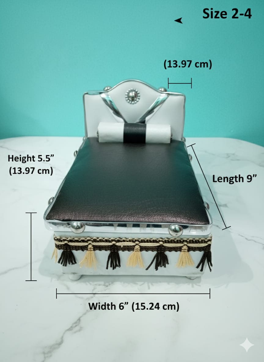 Silver Bed for Laddu Gopal Radha Krishna with black leather top and tassels on a white surface with teal background