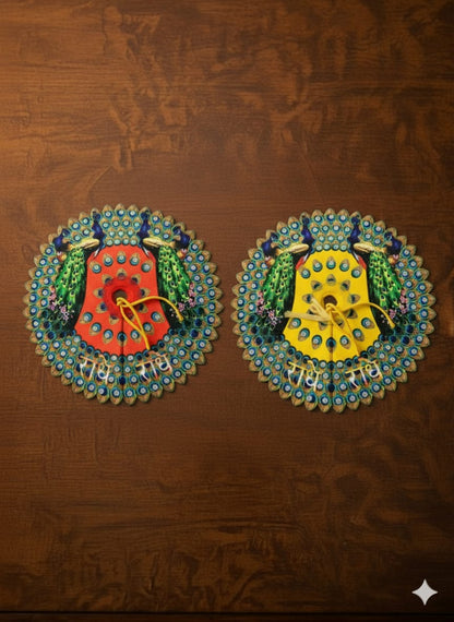 Pair of colorful laddu gopal dress on a brown textured background