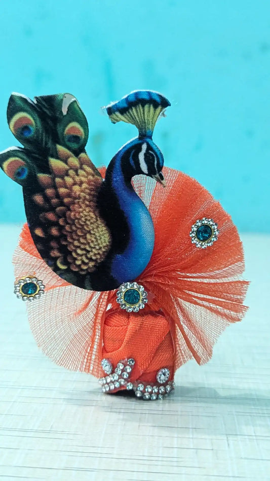 Laddu Gopal Pagdi with peacock design on a pink base against a light blue background